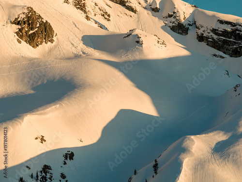 Bilde på lerret Sunlit Snowy Mountain Slopes With Long Shadows and Ski Tracks in British Columbi
