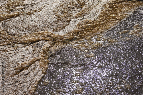 Fotografie Telephoto zoom detail showing the turbulent, bubbling surface of an aeration tank at a wastewater treatment plant, where air is infused to facilitate biological purification