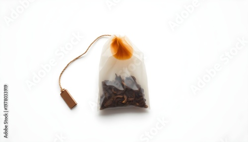 A tea bag filled with loose-leaf tea on a white surface