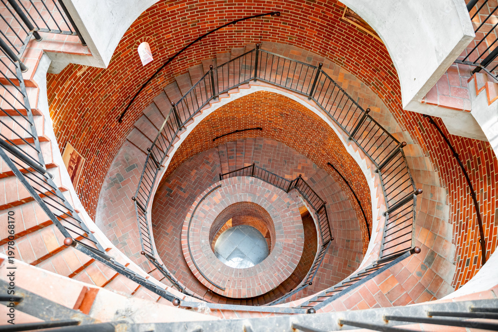 Obraz premium Old spiral staircase in the brick tower
