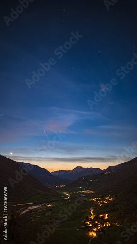 Vertical shot Sunset over alpine valley with village and mountains in Slovenia