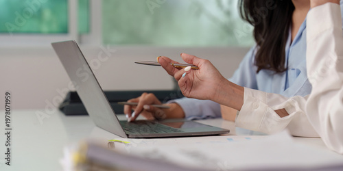 Collaborative financial analysis with laptop and documents