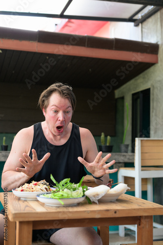 Photos Shocked Man Reacting to Spicy Thai Food Som Tum Papaya Salad Vertical Portrait C