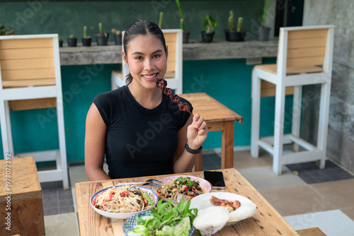 Canvastavla Young Thai Woman Eating Grilled Liver Skewer with Traditional Isan Food at Outdo