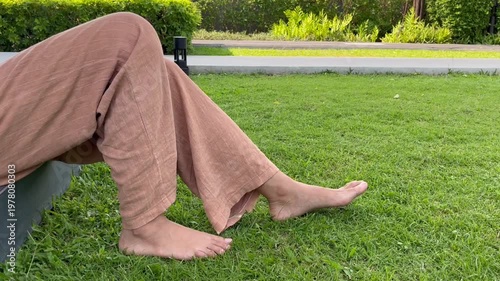 bare feet touching green grass in the park for earthing. High quality photography showing natural healthcare, grounding therapy, relaxation, wellness, and healthy outdoor lifestyle