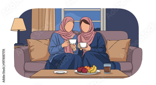 Two Muslim women wearing pink hijabs and blue dresses sitting together on a sofa at home having a conversation while drinking tea and eating fruit.