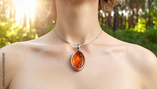 Woman wearing an amber pendant necklace in natural light.