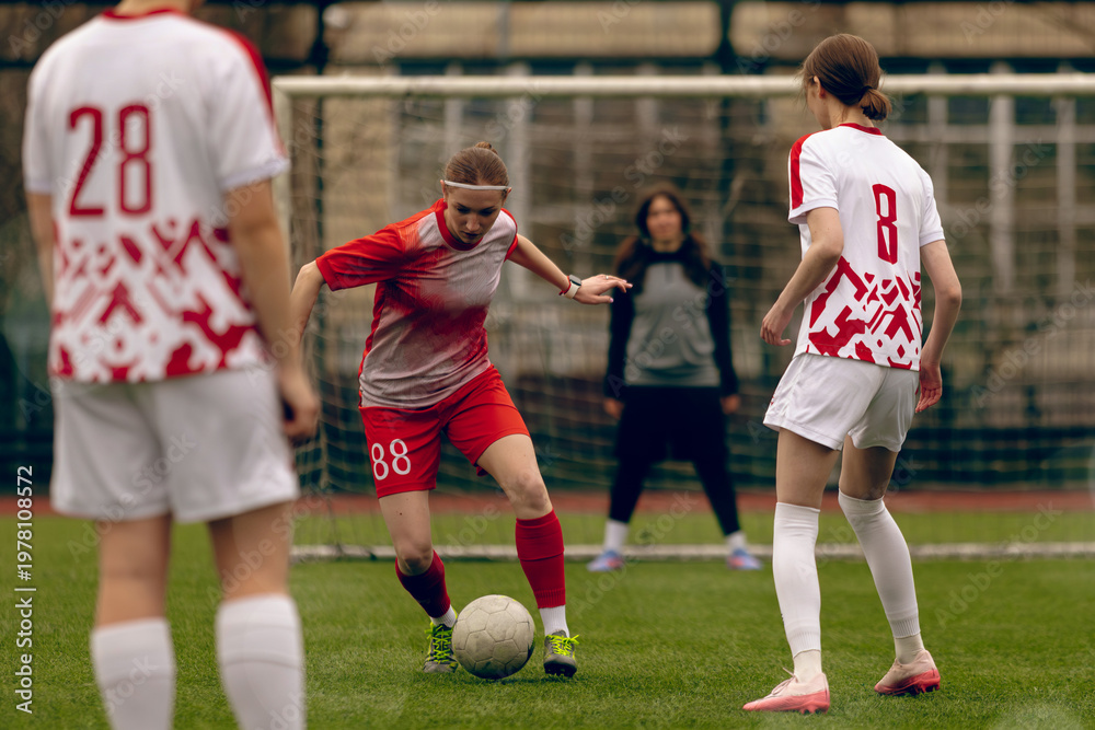 Fototapeta premium Young woman soccer players play football.