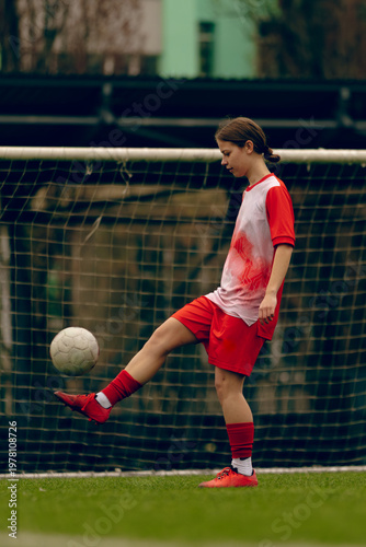 Young woman soccer players play football.