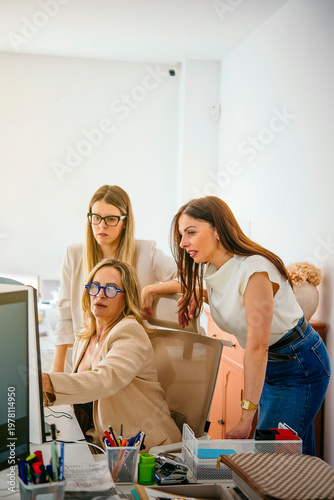 Businesswomen collaborating on computer in office concept