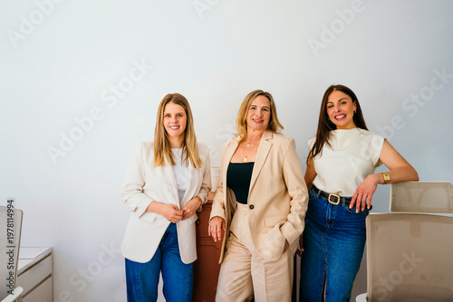 Diverse businesswomen smiling together in modern office