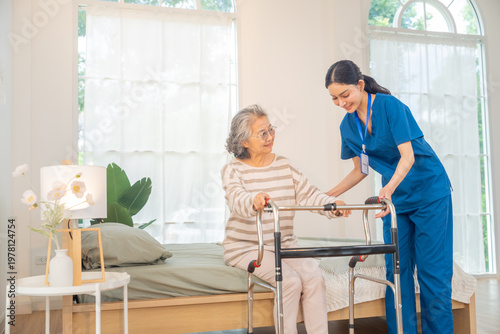 Fotografía Caregiver assisting senior woman using walker at home, elderly mobility support