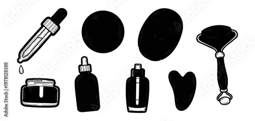 Cosmetic skincare products and tools on black background