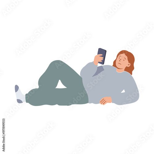 A woman lies on the floor using her smartphone indoors leisurely
