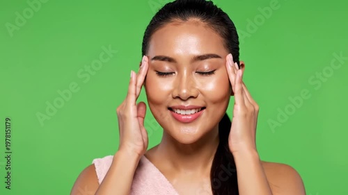 Beautiful Asian Woman with Glowing Skin Touching Her Face with Hands, Smiling