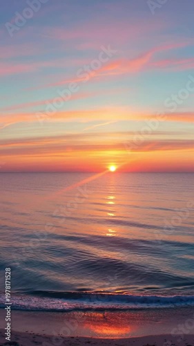 A beautiful sunset over the calm ocean horizon, serene seascape with soft pastel clouds and sun reflection on the water surface.