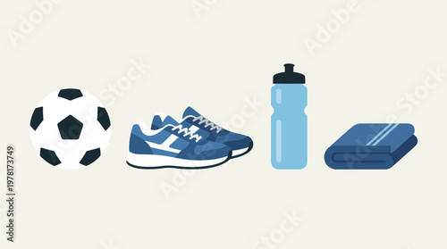 Soccer player equipment laid out on ground includes ball, shoes, water bottle, towel