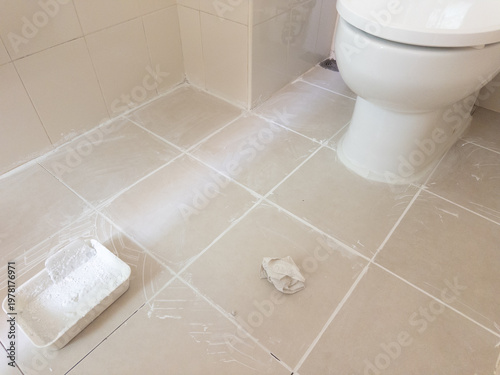 Casual view of bathroom being renovated with new grout and cleaning tools