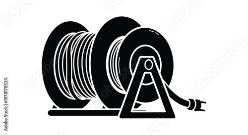 Black and white image of a garden hose reel striking silhouette