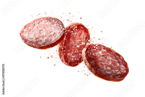Three slices of spiced salami with seasoning falling isolated on transparent background