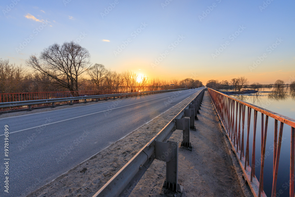 Fototapeta premium Sunset glows over quiet bridge