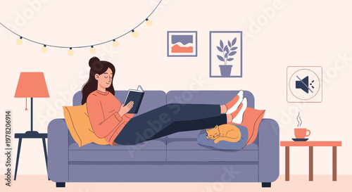 Young woman relaxes on a sofa reading a book with a sleeping cat and decorative string lights in a cozy living room.
