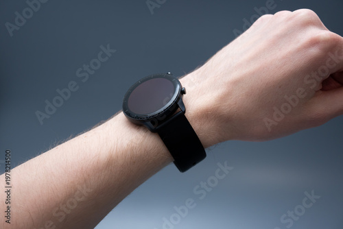 Black Smartwatch on Wrist in Relaxed Pose