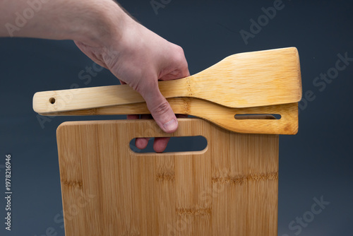 Spatulas on Bamboo Board Against Blue Gradient