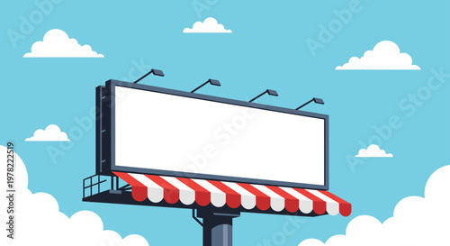 Huge blank billboard stands tall against a bright blue sky with white clouds and a red striped awning below it for outdoor advertising.