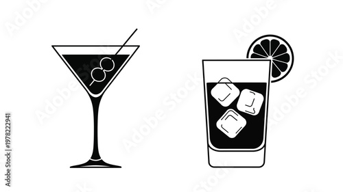 Two cocktail glasses and a lemon slice in stark silhouette