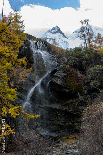 view of autumn highland snow mountain of Yading Nature Reserve, snow-capped mountains, crystal clear lakes, vast grasslands, colorful forests, Shangri-La Town, Daocheng, Sichuan, China