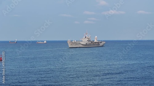 modern naval ship sailing on the open blue ocean. Concept of maritime defense, national security, and military naval infrastructure in a professional setting.