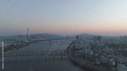 Aerial night view of the illuminated Seoul skyline and Han River from Gwangjin-gu, South Korea.