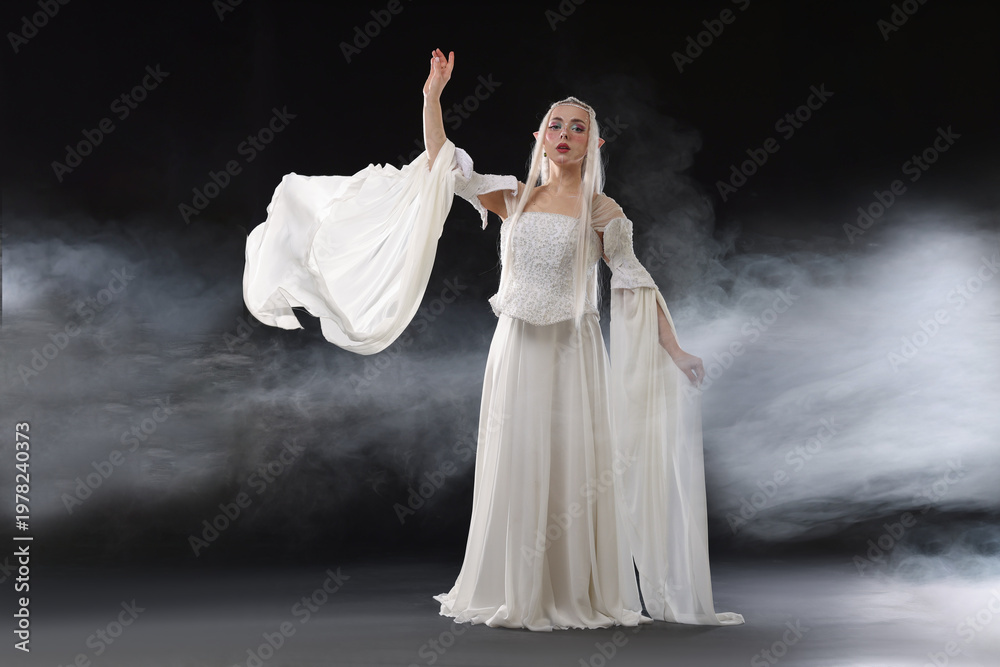 Naklejka premium Beautiful girl dressed as elf on black background with smoke