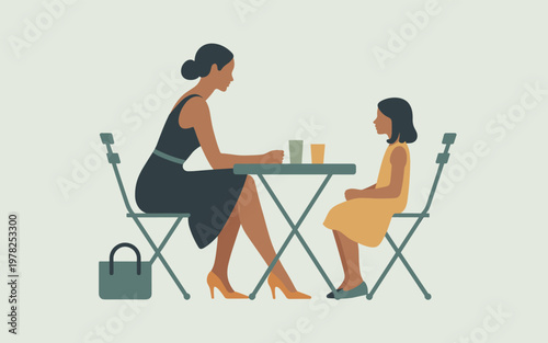 Two women sitting at a small table chatting outdoors in a park
