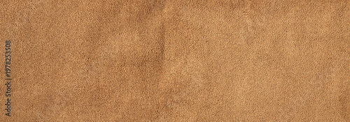 Brown suede leather texture background with soft velvet surface and natural fabric fiber details
