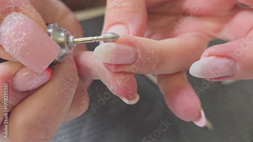 A specialist gives herself a manicure and nail extensions with acrylic and gel. Nail care.