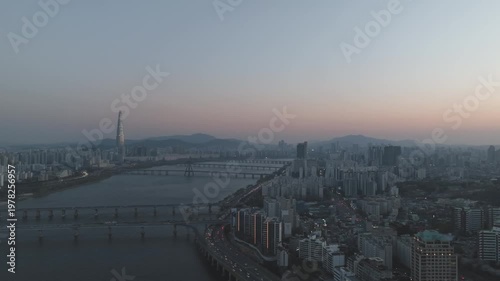 Aerial night view of the illuminated Seoul skyline and Han River from Gwangjin-gu, South Korea.