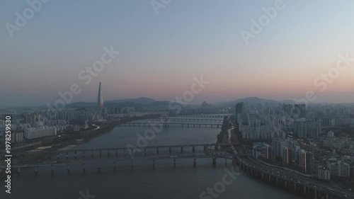 Aerial night view of the illuminated Seoul skyline and Han River from Gwangjin-gu, South Korea.