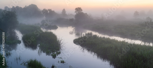 Misty River At Sunrise With Fog Over Water And Trees