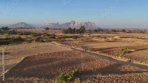 Drone view of the Gheralta range in northern Ethiopia, with cliffs and plateaus stretching across Tigray, wide aerial footage tracking a person on a bike.