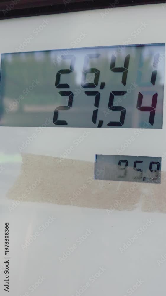 Fuel pump meter counting liters and cost on gas station display during ...