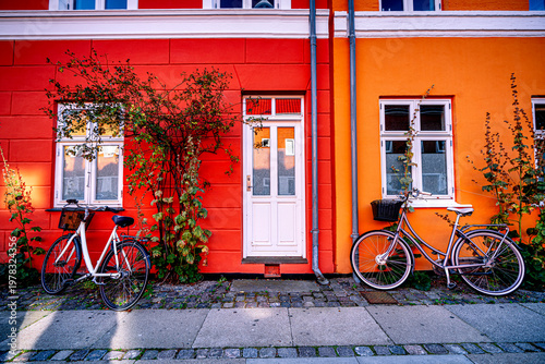 Bicycles on street with colorful facades in Copenhagen, Denmark. Postcard from Scandinavian city.