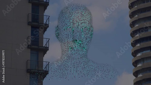 Suspended pointcloud tech artwork forming between towers green core glowing revealing facial detail