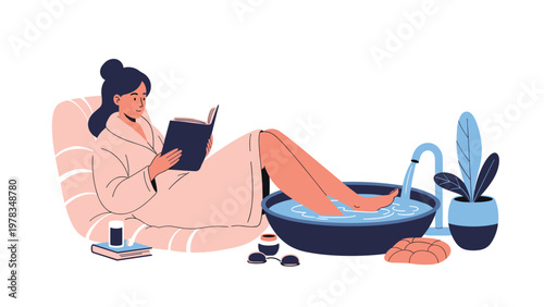 Young woman relaxing in a bathrobe while reading a book and soaking her feet in a warm water bowl for spa treatment.