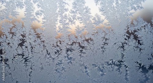 Frosted Window with Intricate Ice Crystal Patterns at Sunrise