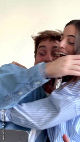 Happy Couple Reacts with Joy and Surprise to Good News on Laptop