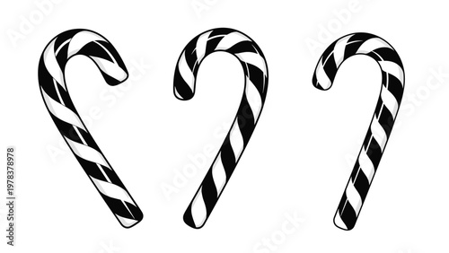 Three traditional candy canes with black and white stripes are arranged in a row against a plain white background.