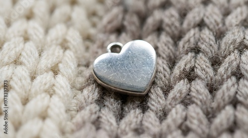Close Up Macro Shot of a Silver Heart Charm on a Textured Knit Fabric shaped