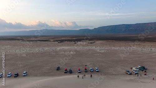 Aerial desert meetup with off-road vehicles at dusk. Zahek Sand Dunes, Sokotra Yemen.